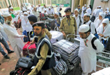 Hajj pilgrims collecting their luggage at Haj House Srinagar. KL Image by Bilal Bahadur
