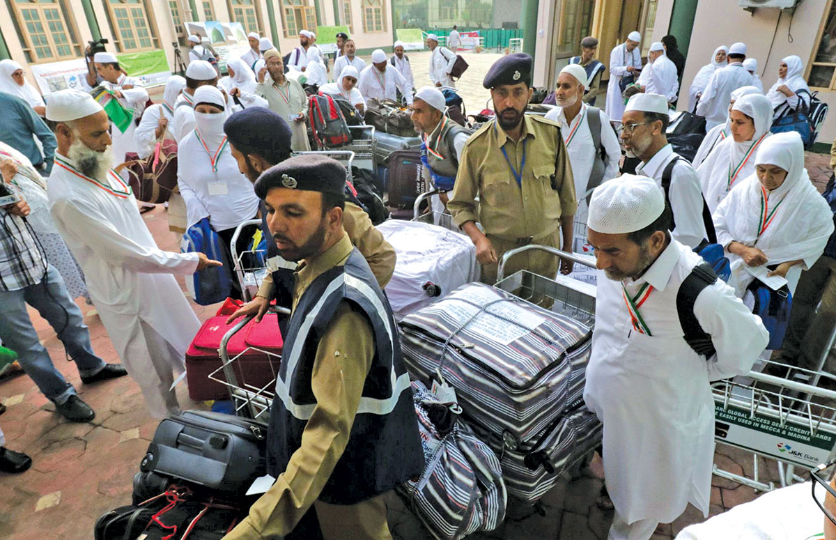 Hajj pilgrims collecting their luggage at Haj House Srinagar. KL Image by Bilal Bahadur