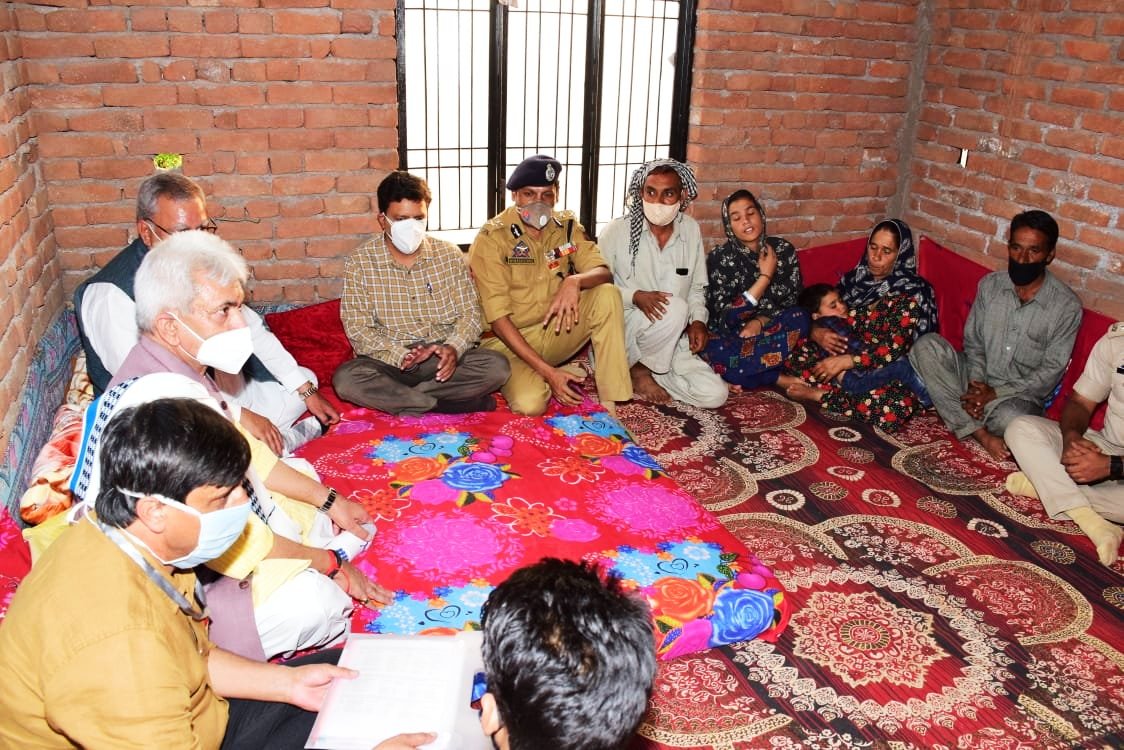 LG JK Manoj Sinha pating his condolences to the families of three Rajouri labourers who were killed in a fake encounter in Shopian on July 18 2020.