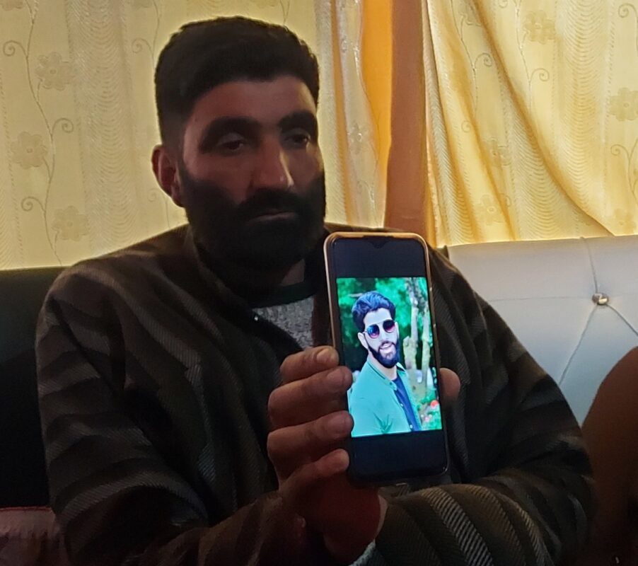 AIjaz Ahmad Ganai’s father showing his slain son’s photograph
