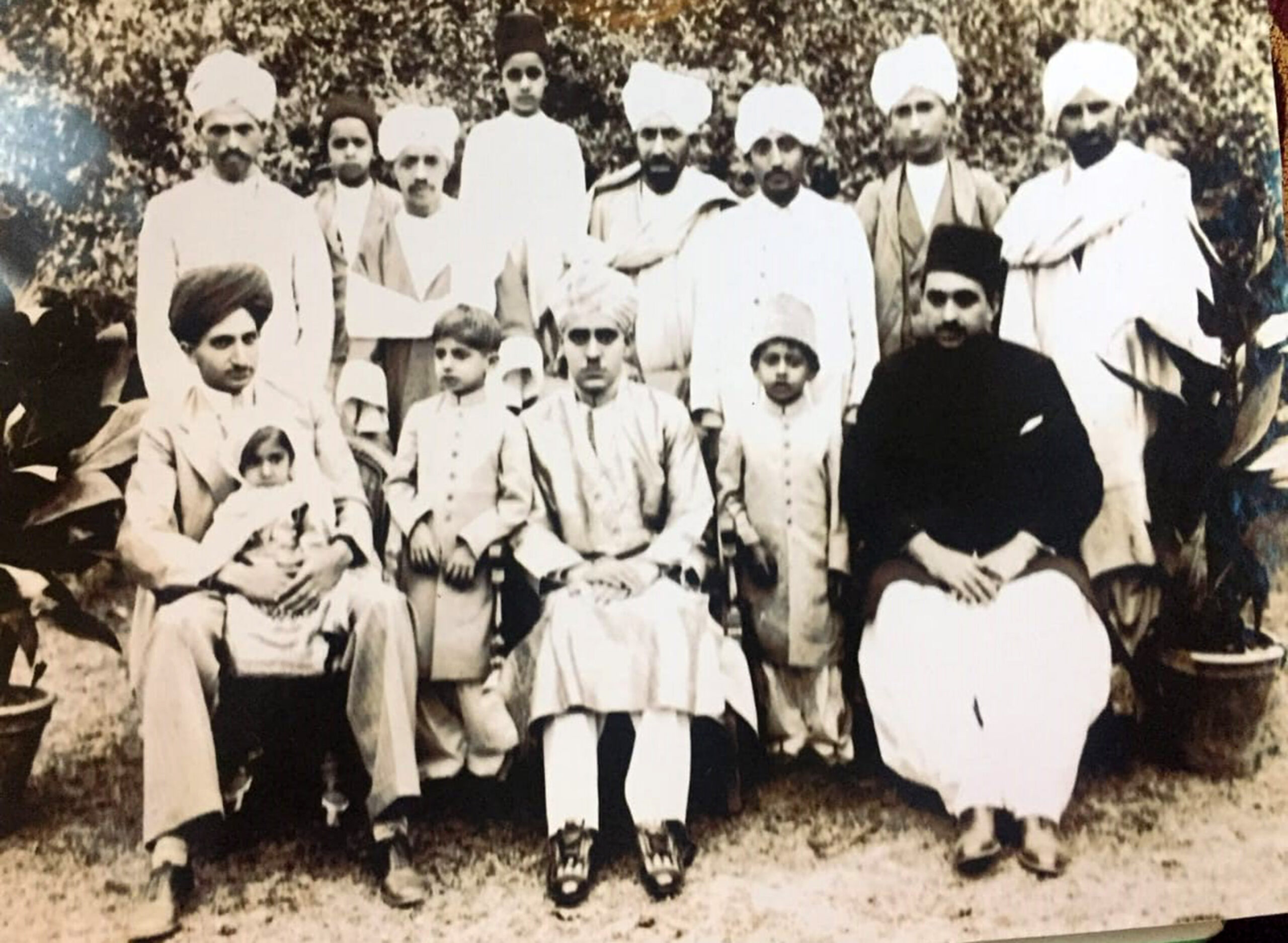 Saududin Shawl in a group photograph with his family members scaled
