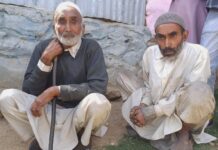 Father Accompanies Disabled Son to Cast Votes, Hoping Social Welfare Aid Resumes Gulam Mohammad Gojar and his son, Gulam Hussan Gojar, waiting at the polling station to cast their votes on May 20, 2024