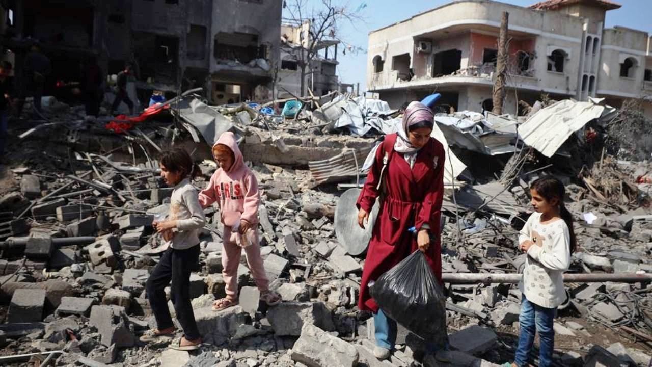 A-UNFPA-photograph-shows-a-fmaily-in-Gaza-looking-through-the-rubble-of-a-destroyed-building