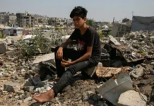 Gaza Enters ‘Death Phase’, Says UN as Hunger Reaches New Heights In-this-UNICEF-photograph-a-young-man-sits-on-the-rubble-of-a-home-in-Gaza-in-2025.