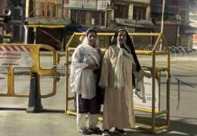 Wearing Burqa, Sakina Itoo Attempts to Visit Mazar-e-Shuhada, Says She Was Stopped Health Minister and National Conference leader Sakina Itoo (right), accompanied by JKNC Women's Wing Provincial President Sabiya Qadri, stands near security barricades in Srinagar after she said she was prevented from visiting the Mazar-e-Shuhada to pay tributes to the July 13, 1931 martyrs on Sunday