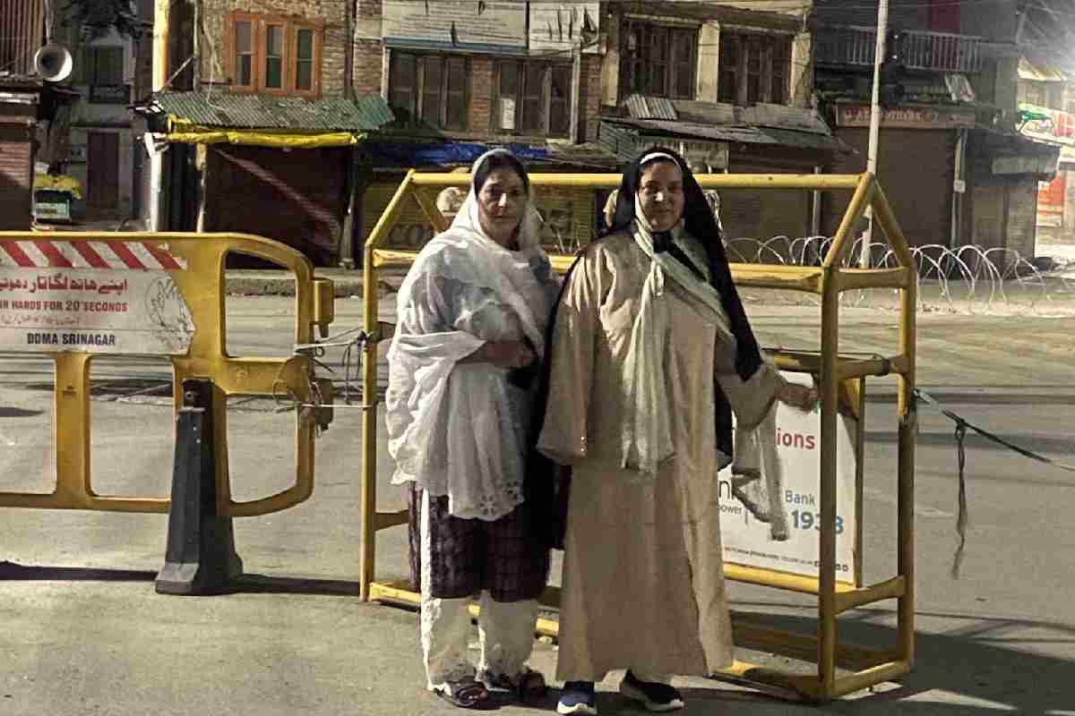 Health Minister and National Conference leader Sakina Itoo (right), accompanied by JKNC Women's Wing Provincial President Sabiya Qadri, stands near security barricades in Srinagar after she said she was prevented from visiting the Mazar-e-Shuhada to pay tributes to the July 13, 1931 martyrs on Sunday