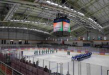 Players from the two teams line up on the ice during the inauguration of Ladakh’s first international-level artificial ice hockey rink at NDS Stadium in Leh