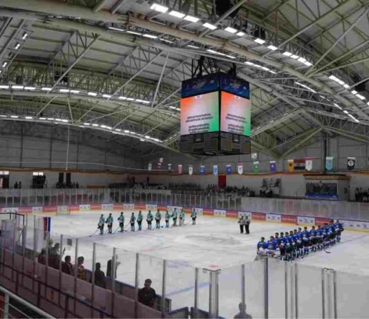 Players from the two teams line up on the ice during the inauguration of Ladakh’s first international-level artificial ice hockey rink at NDS Stadium in Leh