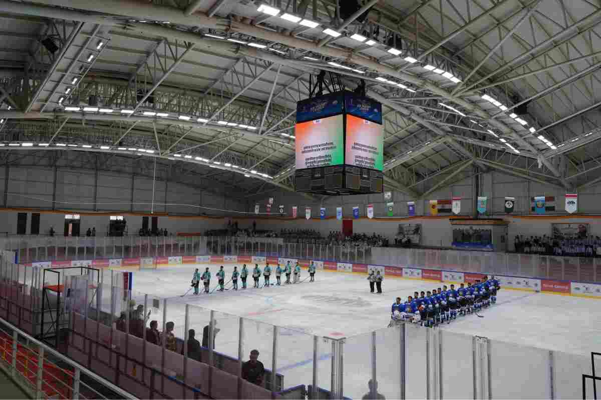 Players from the two teams line up on the ice during the inauguration of Ladakh’s first international-level artificial ice hockey rink at NDS Stadium in Leh